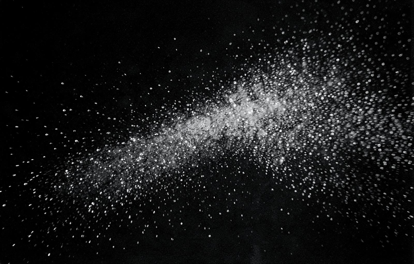 Fine water mist droplets against a dark background